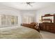Spacious bedroom with a large window, shutters, dresser and mirror, plus a comfortable sitting area at 11187 E De La O Rd, Scottsdale, AZ 85255