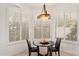 Eat-in breakfast nook featuring plantation shutters and a modern chandelier at 11187 E De La O Rd, Scottsdale, AZ 85255