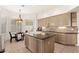 Kitchen with tile backsplash, granite counters, an island with a sink, and a breakfast nook at 11187 E De La O Rd, Scottsdale, AZ 85255