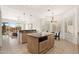 Open kitchen with granite counters, a breakfast bar, white cabinets, and a pass through window at 11187 E De La O Rd, Scottsdale, AZ 85255