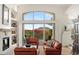 Cozy living area with a stone fireplace, built-in shelves, and sliding glass doors leading to the backyard at 11187 E De La O Rd, Scottsdale, AZ 85255