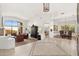 Spacious living room featuring tile flooring, white walls, and an open floorplan with ample natural light at 11187 E De La O Rd, Scottsdale, AZ 85255