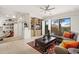 Bright and spacious living room with built-in shelving, a comfortable sofa, and backyard views at 11187 E De La O Rd, Scottsdale, AZ 85255