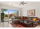 Comfortable living room with views of the backyard pool and patio area through large sliding doors at 11187 E De La O Rd, Scottsdale, AZ 85255