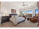 Spacious main bedroom with sitting area and views of the blooming backyard and covered patio at 11187 E De La O Rd, Scottsdale, AZ 85255