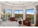 Bright main bedroom sitting area with backyard views and plantation shutters at 11187 E De La O Rd, Scottsdale, AZ 85255