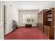 Bright office with a built-in wall unit, and a view of greenery through shuttered windows at 11187 E De La O Rd, Scottsdale, AZ 85255