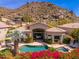 Beautiful backyard pool with mountain views and lush flowering plants and desert landscaping at 11187 E De La O Rd, Scottsdale, AZ 85255