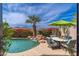 Inviting pool area features a waterfall, lush landscaping, and comfortable seating for relaxing outdoors at 11187 E De La O Rd, Scottsdale, AZ 85255