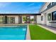 Backyard view from the pool to the covered outdoor dining and bar area and the main house with bar seating at 11649 N Miller Rd, Scottsdale, AZ 85260