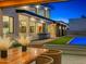 Backyard view from covered patio with a manicured lawn, pool, and outdoor bar with seating at the main house at 11649 N Miller Rd, Scottsdale, AZ 85260