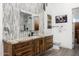 Bathroom featuring modern design with decorative wall tiles, a wood vanity, and contemporary fixtures at 11649 N Miller Rd, Scottsdale, AZ 85260