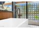 Spa-like bathroom featuring a soaking tub and decorative screen offering privacy and style at 11649 N Miller Rd, Scottsdale, AZ 85260