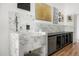 Dog bathing station featuring white tiled backsplash, shower head, and integrated storage cabinets at 11649 N Miller Rd, Scottsdale, AZ 85260