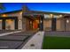 Modern home showcasing unique architectural design, desert landscaping, and a stylish entrance at 11649 N Miller Rd, Scottsdale, AZ 85260