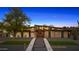 Stunning modern home with desert landscaping, a geometric walkway, and stylish exterior lighting at 11649 N Miller Rd, Scottsdale, AZ 85260