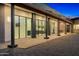 Modern home exterior with large windows and covered patio at 11649 N Miller Rd, Scottsdale, AZ 85260