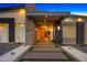 Inviting modern home entrance featuring decorative brickwork, concrete pathway, and desert landscaping at 11649 N Miller Rd, Scottsdale, AZ 85260
