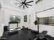 Bright home gym with high ceilings, ample equipment, and a large mirror at 11649 N Miller Rd, Scottsdale, AZ 85260