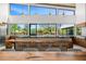 Bright kitchen featuring a live edge island, modern lighting, and large windows showcasing the backyard at 11649 N Miller Rd, Scottsdale, AZ 85260