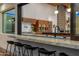 Pass-through kitchen window with bar seating and a view of the modern kitchen at 11649 N Miller Rd, Scottsdale, AZ 85260