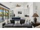 Stylish living room showcasing modern furnishings, an entertainment center, and an open layout to the kitchen at 11649 N Miller Rd, Scottsdale, AZ 85260