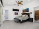 Spacious main bedroom with natural light, stylish décor, and a door leading to the exterior at 11649 N Miller Rd, Scottsdale, AZ 85260