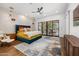 Spacious main bedroom with a private patio, accent lighting, and stylish decor at 11649 N Miller Rd, Scottsdale, AZ 85260