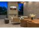 Outdoor living area with brick and decorative tile accents, a gas fireplace, an outdoor TV, and comfortable seating at 11649 N Miller Rd, Scottsdale, AZ 85260