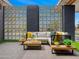 Relaxing outdoor patio featuring a comfortable seating area with modern accent walls at 11649 N Miller Rd, Scottsdale, AZ 85260