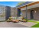 Charming patio space with cozy furniture, accent privacy walls, and manicured artificial lawn at 11649 N Miller Rd, Scottsdale, AZ 85260