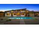 Modern home's pool with a sleek design, surrounded by desert landscaping and an outdoor kitchen at 11649 N Miller Rd, Scottsdale, AZ 85260
