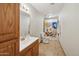 Well-lit bathroom with wood cabinets and colorful shower curtain at 153 W Hillside St, Mesa, AZ 85201