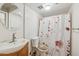 Bright bathroom with floral shower curtain and white sink at 153 W Hillside St, Mesa, AZ 85201