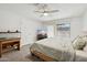Well-lit bedroom with fan, large window, and neutral colors at 153 W Hillside St, Mesa, AZ 85201