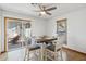 Cozy dining area with a modern ceiling fan, natural light, and backyard access at 153 W Hillside St, Mesa, AZ 85201