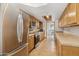 Bright kitchen with stainless steel appliances and warm-toned wood cabinets at 153 W Hillside St, Mesa, AZ 85201