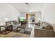 Comfortable living room with neutral tones, tile flooring, and a sliding glass door at 153 W Hillside St, Mesa, AZ 85201