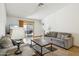 Neutral living room featuring tile flooring, couches and backyard access via sliding door at 153 W Hillside St, Mesa, AZ 85201
