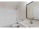 Bright, clean bathroom featuring a tub/shower combo, modern vanity, and a large mirror at 16585 W Tonto St, Goodyear, AZ 85338