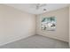 Bright bedroom with neutral carpet and a window providing natural light and neighborhood views at 16585 W Tonto St, Goodyear, AZ 85338