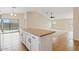 Bright kitchen featuring an island with tan countertops and sliding doors opening to the outdoor pool area at 16585 W Tonto St, Goodyear, AZ 85338