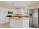 Bright kitchen featuring stainless steel appliances, white cabinets, and central island at 16585 W Tonto St, Goodyear, AZ 85338