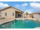 Private backyard oasis with a sparkling pool, patio space, and mature landscaping at 16585 W Tonto St, Goodyear, AZ 85338