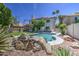 Serene backyard featuring a sparkling pool, verdant lawn, and inviting patio, ideal for outdoor living at 1720 W Orchid Ln, Chandler, AZ 85224