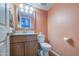 Cozy bathroom with pink walls, a vanity and good lighting at 1720 W Orchid Ln, Chandler, AZ 85224