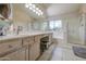 Bathroom with double sink vanity, large mirror, and a separate shower and tub at 1720 W Orchid Ln, Chandler, AZ 85224