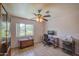 Bedroom with ample natural light, ceiling fan, and closet space for storage at 1720 W Orchid Ln, Chandler, AZ 85224