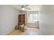 Bright bedroom with ceiling fan, light wood floors, large window and storage shelves at 1720 W Orchid Ln, Chandler, AZ 85224