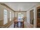 The dining room has a long table with a view of the back yard and a bright window at 1720 W Orchid Ln, Chandler, AZ 85224